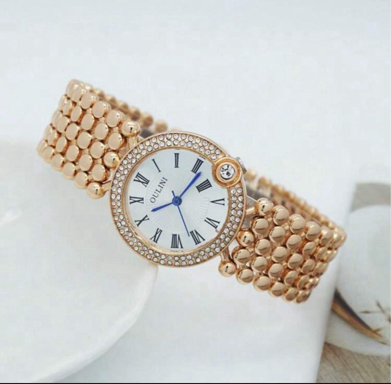 ساعة نسائية أنيقة من OULINI – تصميم دائري مرصع، أرقام رومانية، كوارتز، باللون الروز جولد LRMW 20234